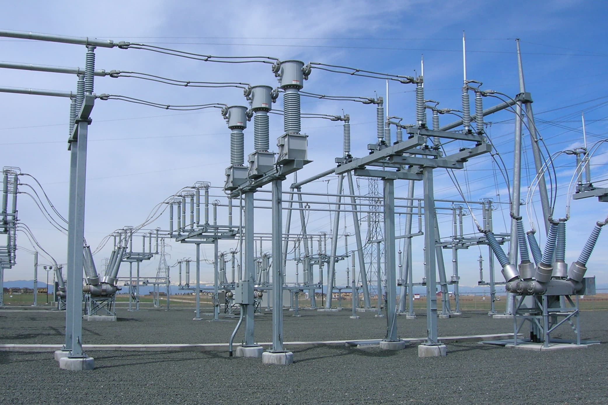 High-voltage electrical substation with transformers and overhead bus work